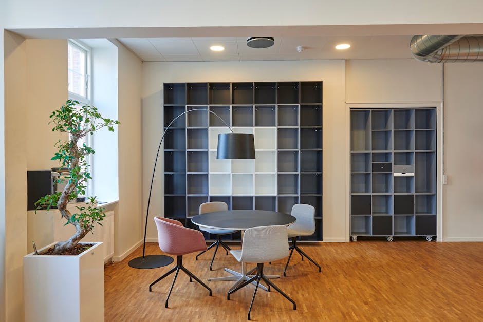 Bright and stylish office space with contemporary furniture and open shelving